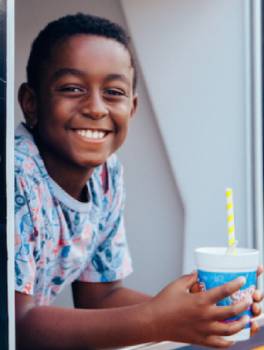 Boy smiling with cup of shaved ice